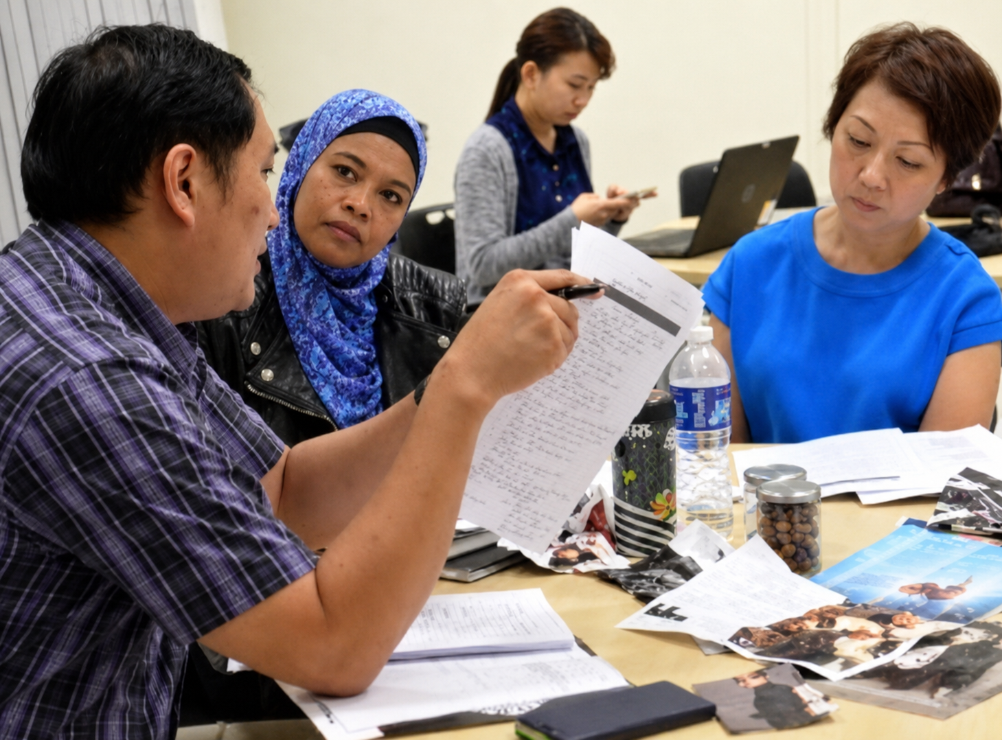 A group of Art Teacher Leaders engaged in conversation and discussion during a workshop.